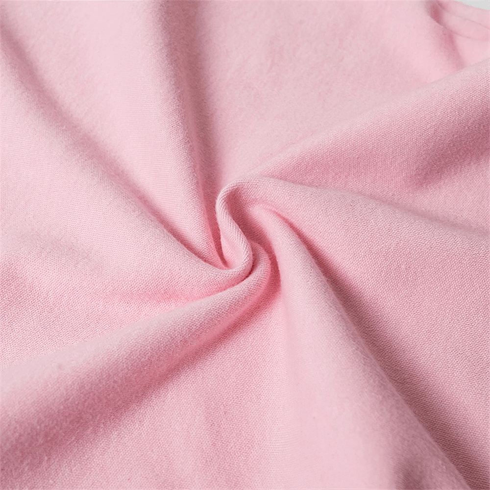 Close-up of pink cotton fabric showing soft texture and weave, perfect for solid color long-sleeved tops with versatile design.